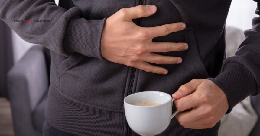 Person holding stomach in pain after drinking coffee